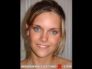 Monica lion is sited on a sofa, legs appart and looking at you