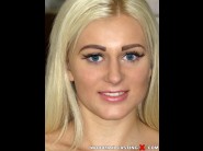 Roxy black is sited on a sofa, legs appart and looking at you