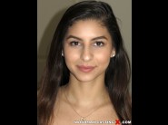 Nina north is sited on a sofa, legs appart and looking at you