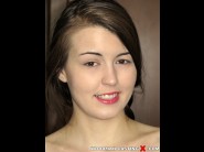 Cindy shine is sited on a sofa, legs appart and looking at you