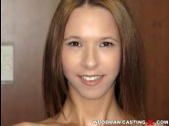 Paris devine is sited on a sofa, legs appart and looking at you