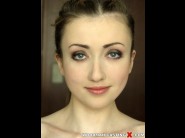 Empera is sited on a sofa, legs appart and looking at you