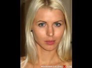 Lynna nilsson is sited on a sofa, legs appart and looking at you