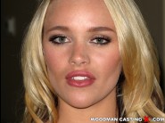 Alexis monroe is sited on a sofa, legs appart and looking at you