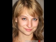 Stepanska is sited on a sofa, legs appart and looking at you