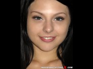 Megan sage is sited on a sofa, legs appart and looking at you