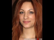 Jennifer pierce is sited on a sofa, legs appart and looking at you