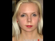 Martine sun is sited on a sofa, legs appart and looking at you