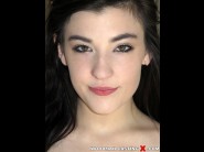 Jenna reid is sited on a sofa, legs appart and looking at you