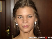 Sara kay is sited on a sofa, legs appart and looking at you