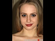 Alice page is sited on a sofa, legs appart and looking at you