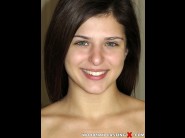 Leah gotti is sited on a sofa, legs appart and looking at you