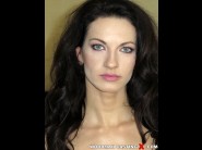 Linda moretti is sited on a sofa, legs appart and looking at you