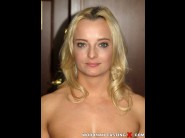 Victoria pure is sited on a sofa, legs appart and looking at you