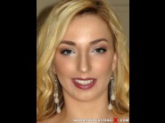 Zoe parker is sited on a sofa, legs appart and looking at you