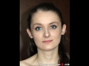 Jessie blue is sited on a sofa, legs appart and looking at you