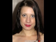 Tereza bizarre is sited on a sofa, legs appart and looking at you