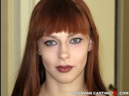 Alexa nova is sited on a sofa, legs appart and looking at you