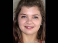 Renata fox is sited on a sofa, legs appart and looking at you