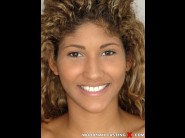 Venus afrodita is sited on a sofa, legs appart and looking at you