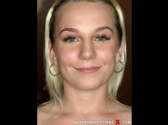 Dominikka is sited on a sofa, legs appart and looking at you