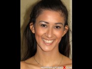 Darcia lee is sited on a sofa, legs appart and looking at you