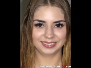 Julia red is sited on a sofa, legs appart and looking at you