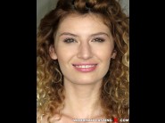 Candice demellza is sited on a sofa, legs appart and looking at you