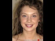 Elena koshka is sited on a sofa, legs appart and looking at you