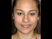 Angie young is sited on a sofa, legs appart and looking at you