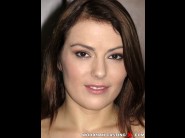 Samantha joons is sited on a sofa, legs appart and looking at you