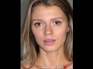 Mary kalisy is sited on a sofa, legs appart and looking at you