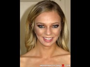 Tiffany watson is sited on a sofa, legs appart and looking at you