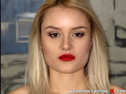 Scarlett knight is sited on a sofa, legs appart and looking at you