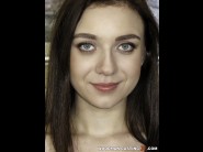 Kira axe is sited on a sofa, legs appart and looking at you