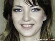 Kristin romance is sited on a sofa, legs appart and looking at you